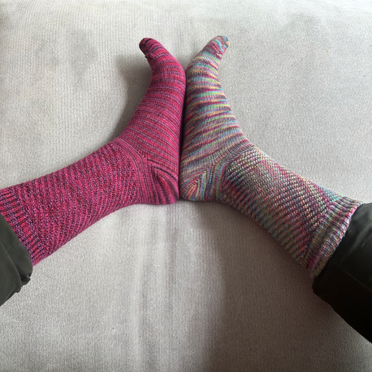 Colorful socks on a light gray surface