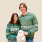 Two people wearing green patterned sweaters with a Alpaca on a beige background