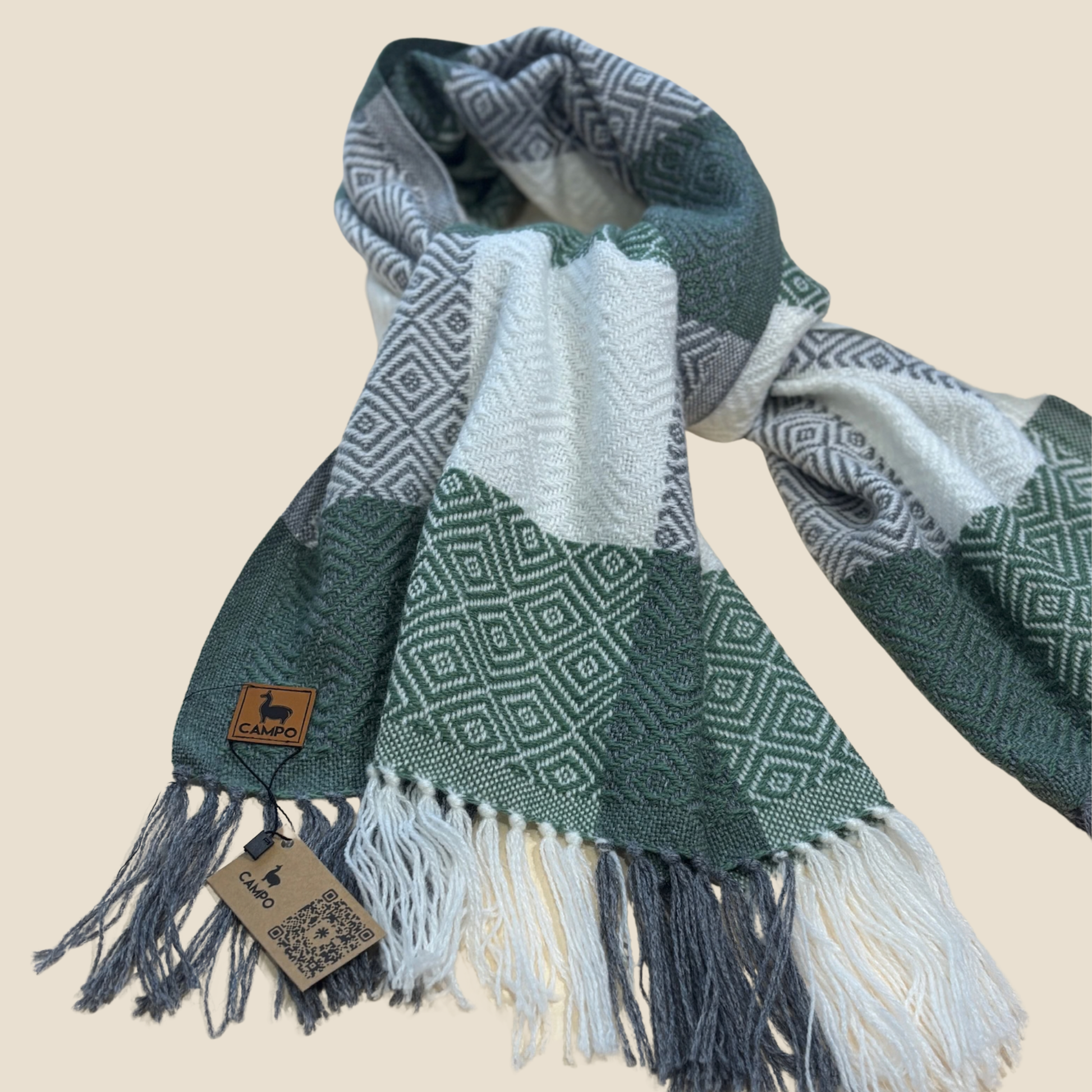 Green and gray patterned scarf with fringes on a beige background