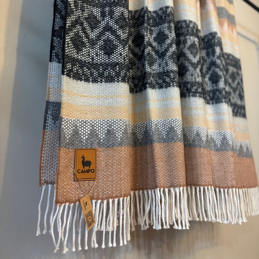 Black medley patterned scarf with fringes and a visible brand tag on a neutral background