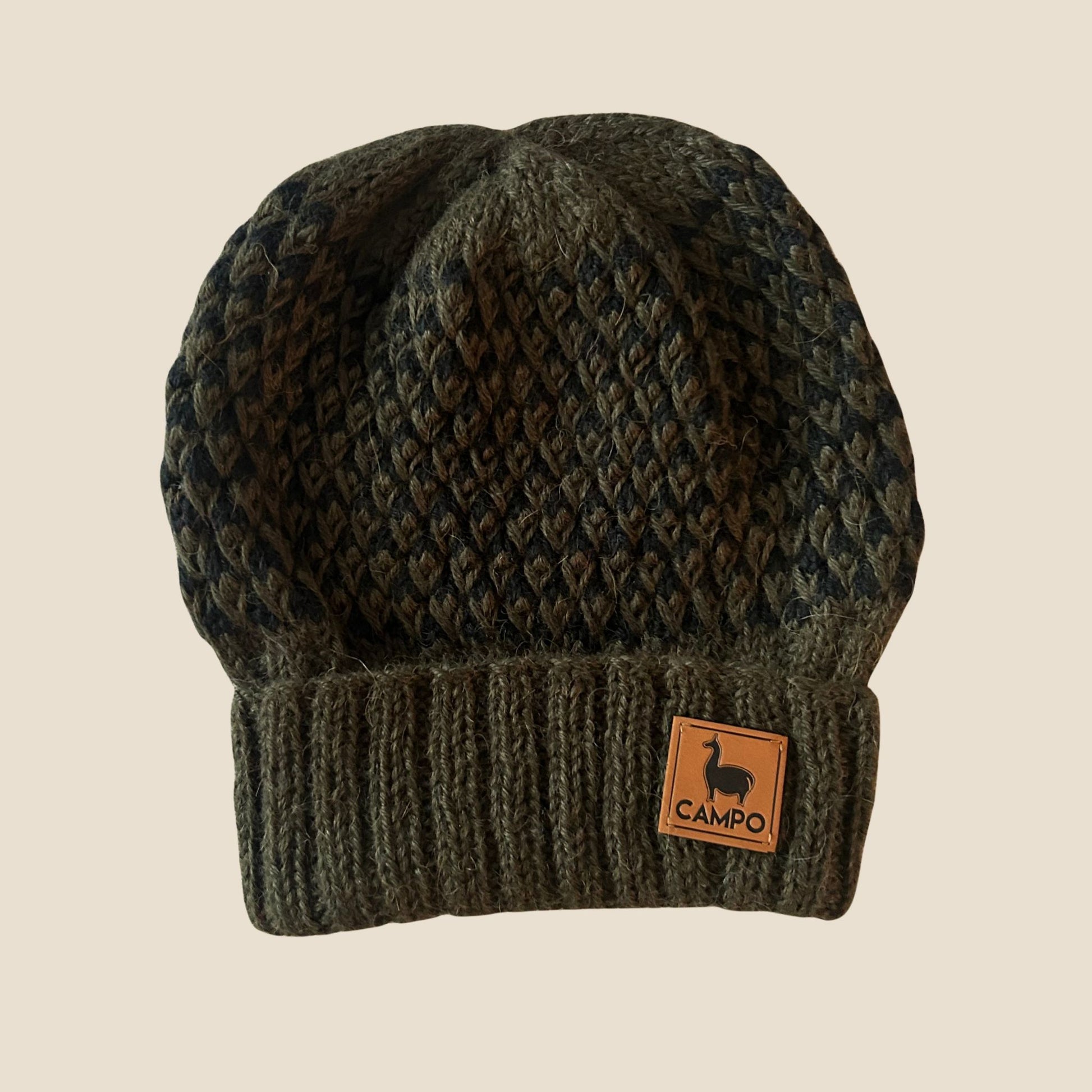 Turkish knit beanie with a visible brand label on a beige background
