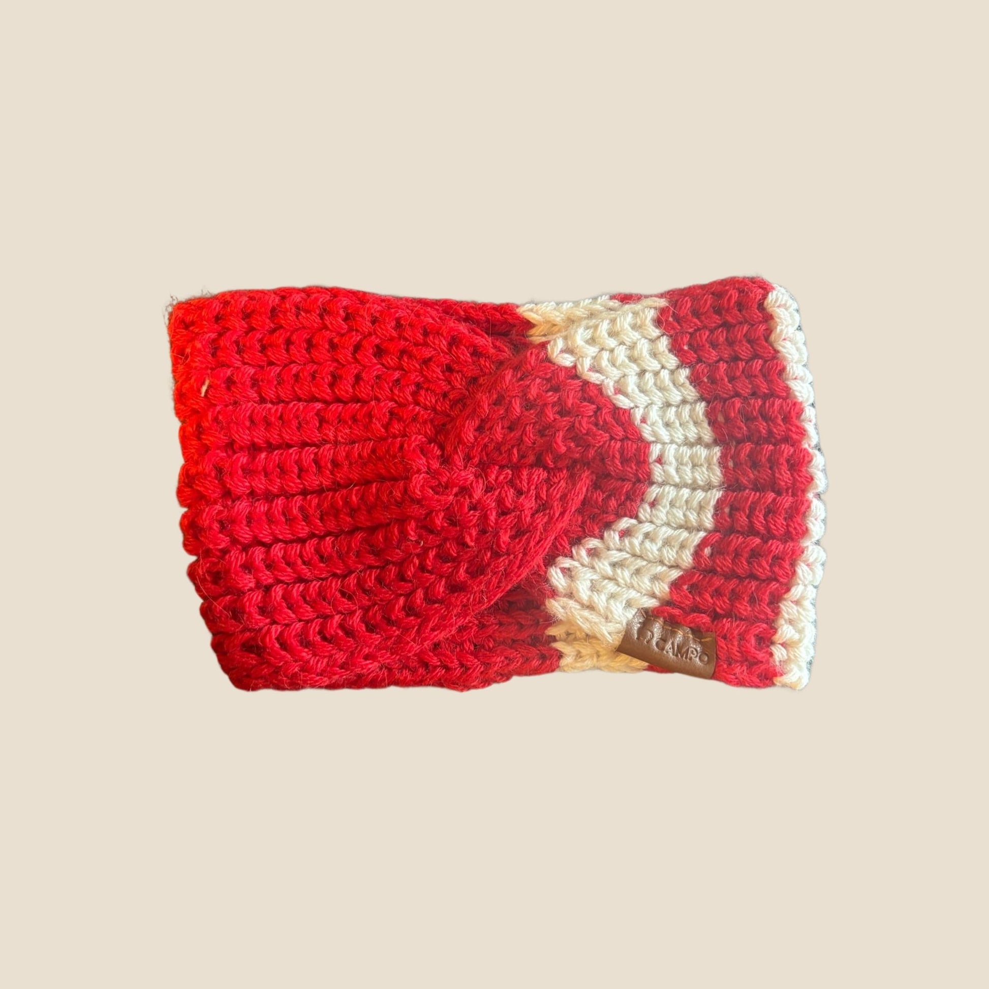 Red and white crocheted headband on a beige background