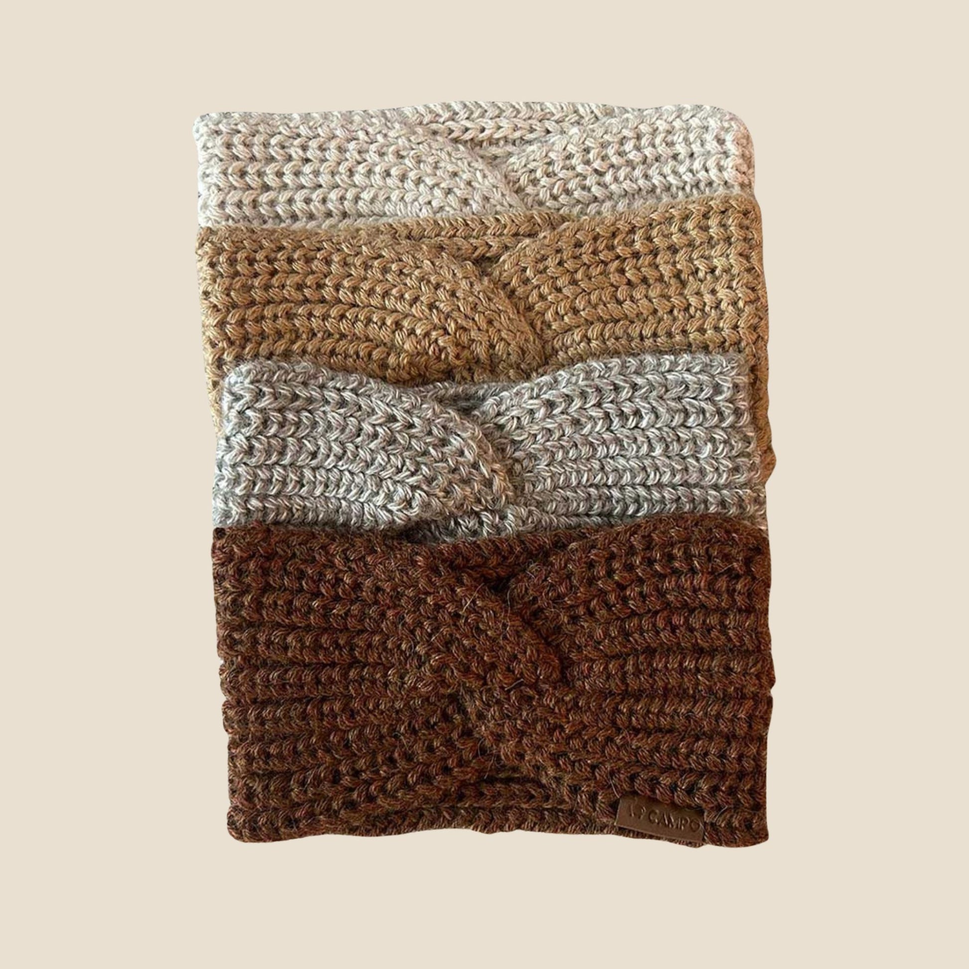 Twisted headband with brown, beige, and gray pattern on a beige background