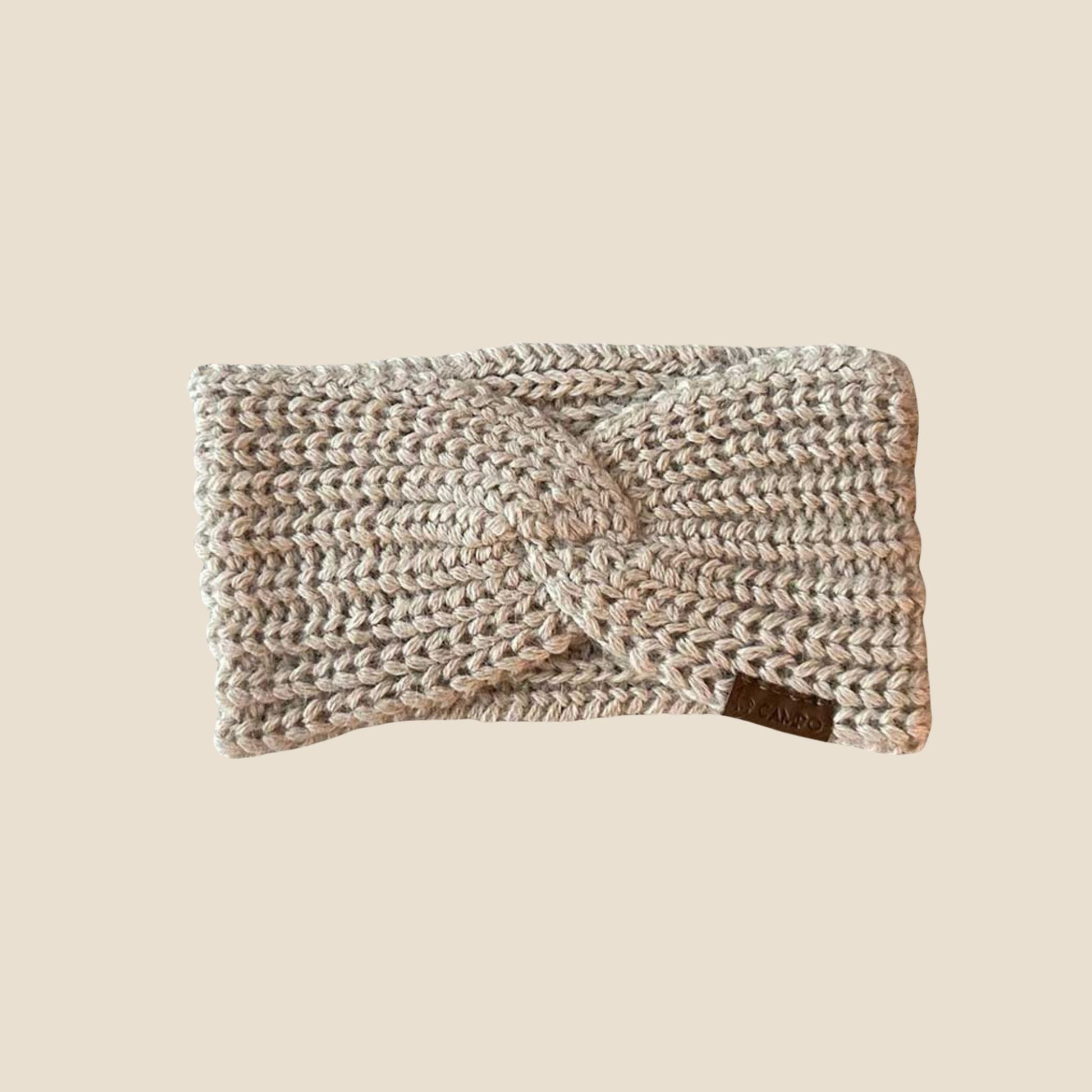 Knitted headband on a beige background