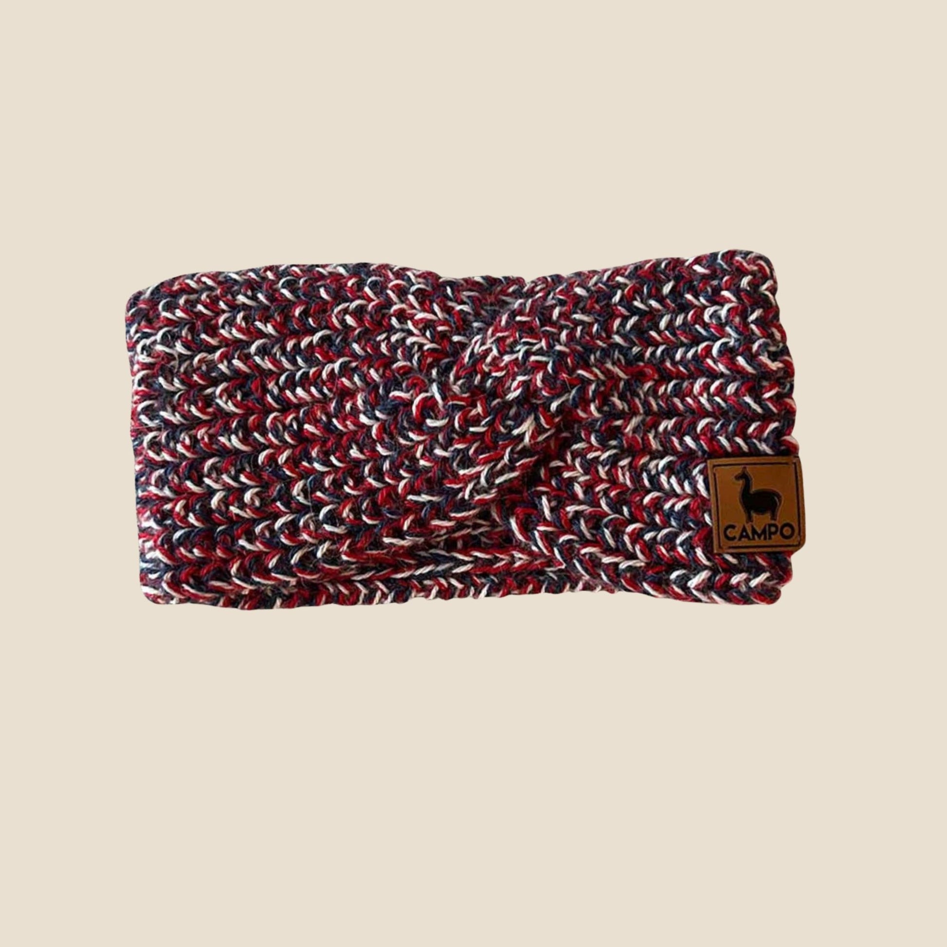 Knitted headband with a brown label on a beige background