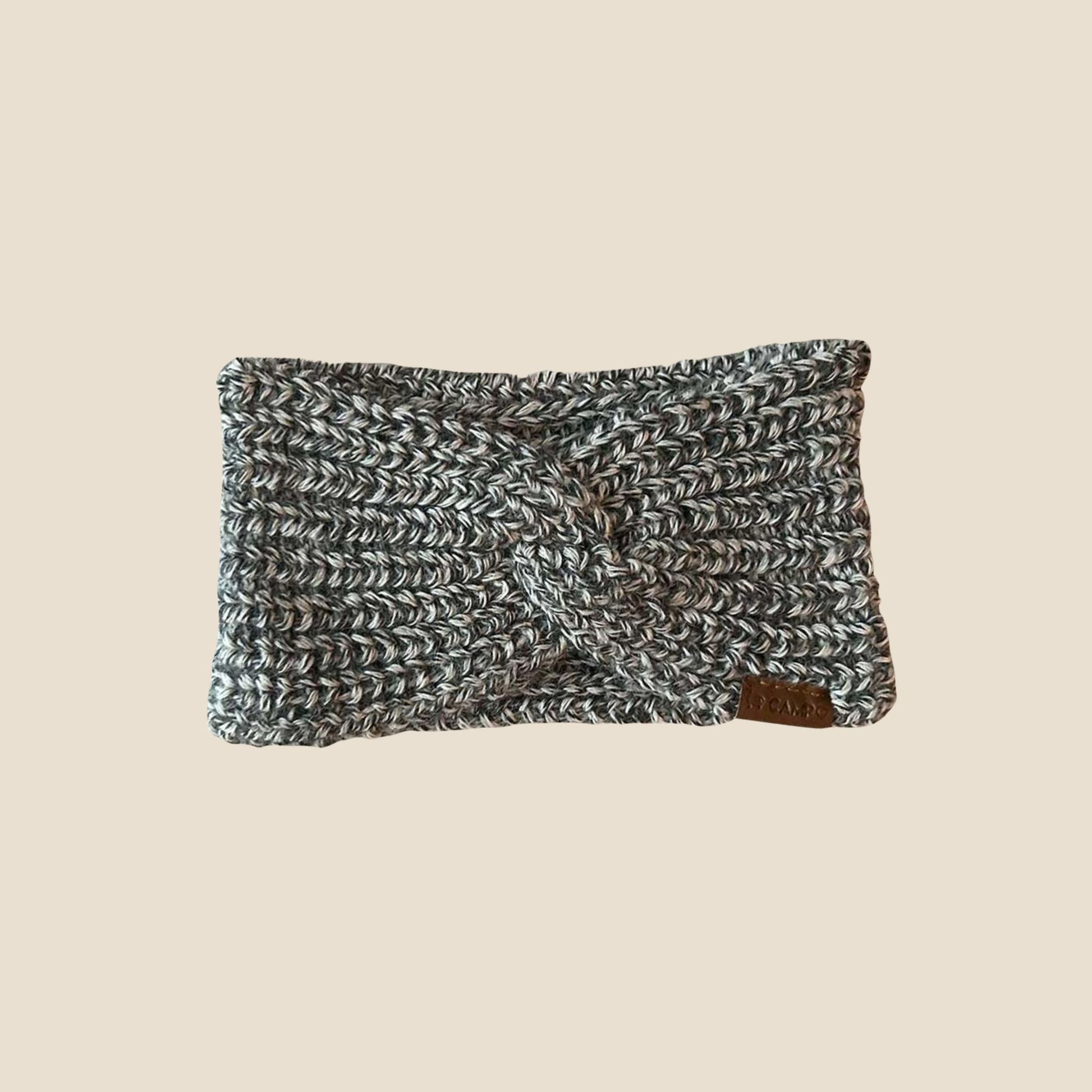 Twisted headband with a textured pattern on a beige background