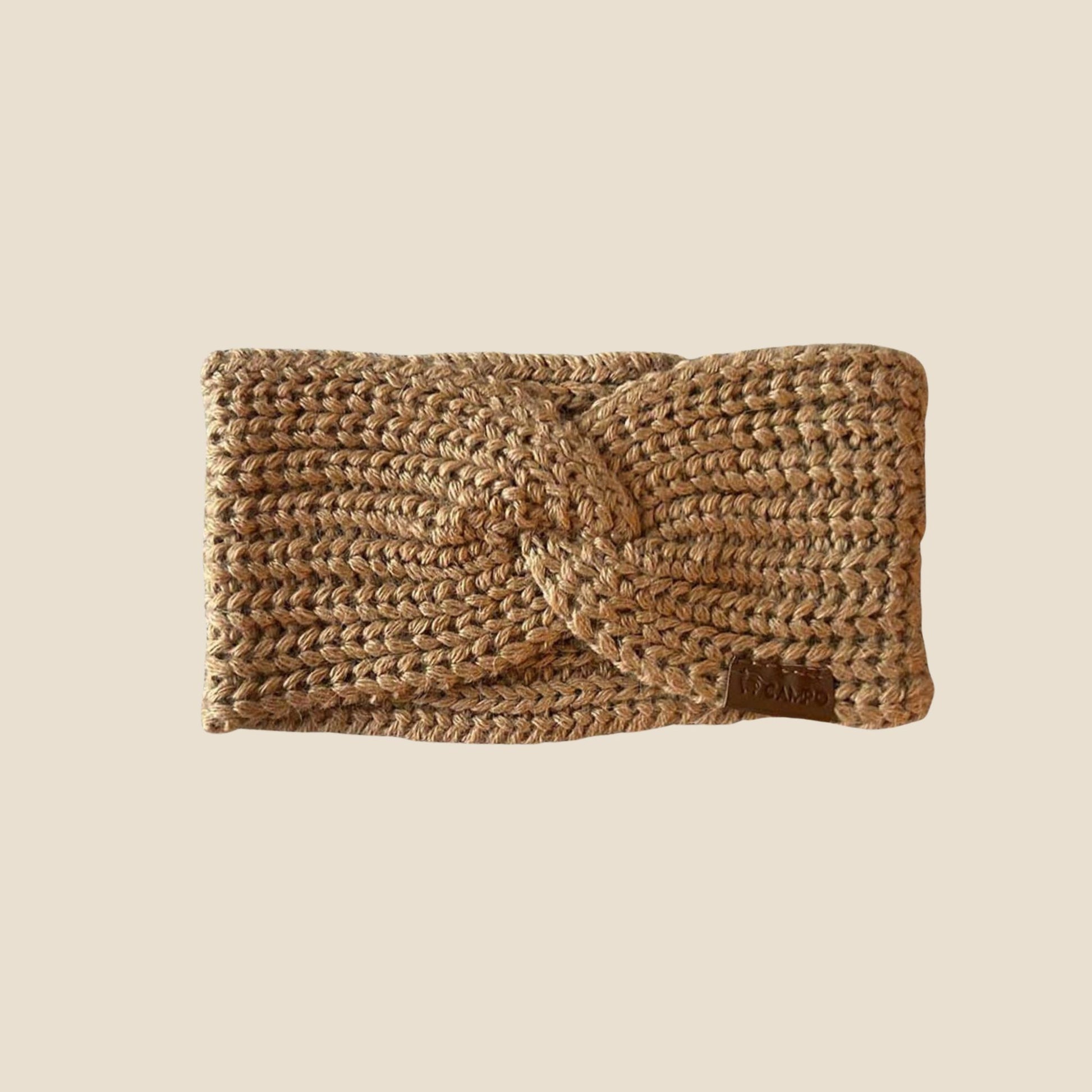 Twisted tan headband on a beige background