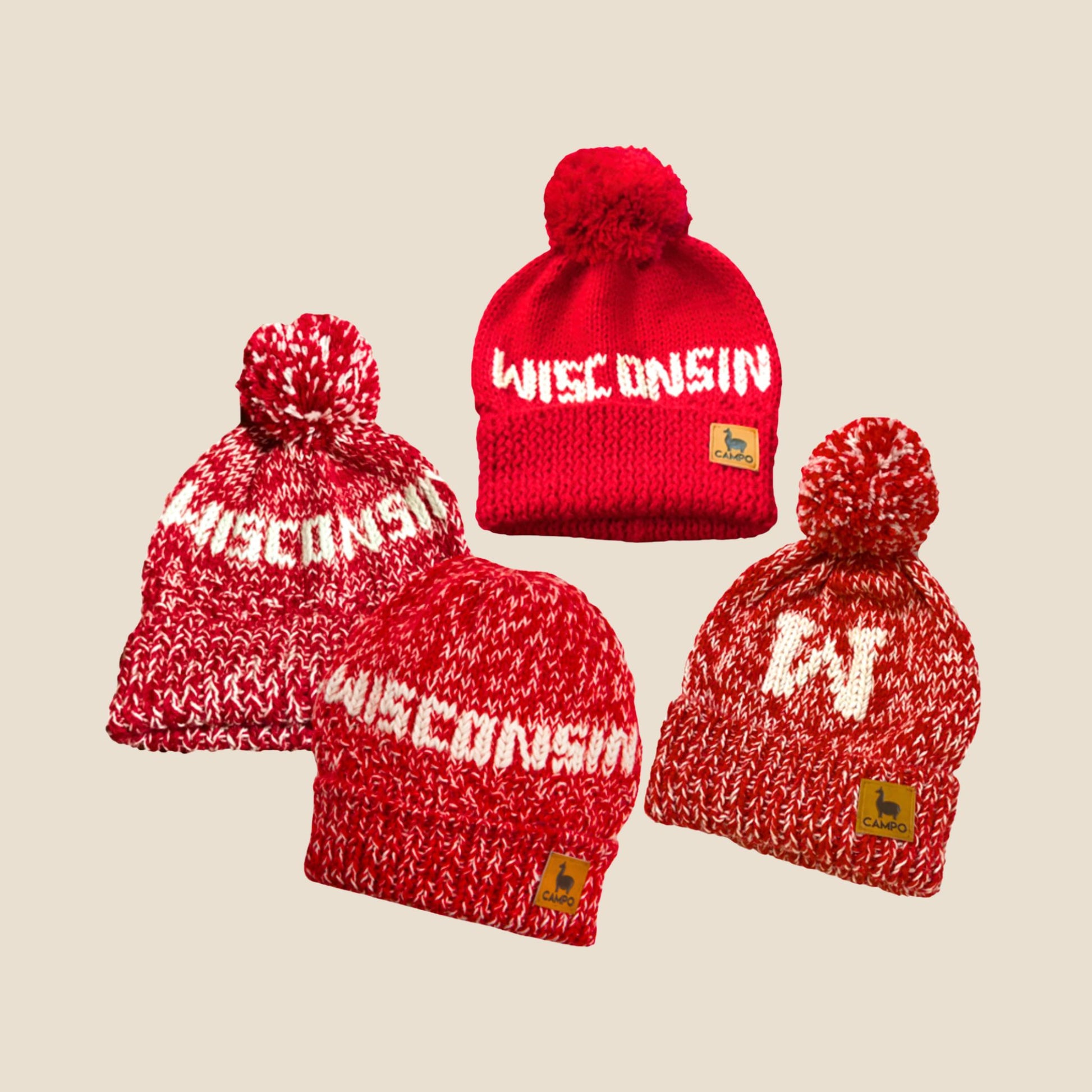 Red and white 'Wisconsin' beanie with pom-poms on a beige background