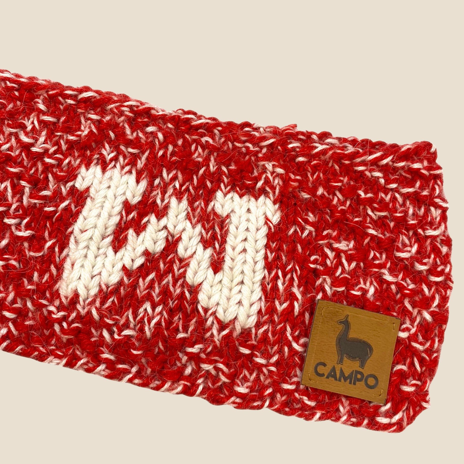 Red and white Alpaca Headband with 'CAMPO' brand label on a beige background