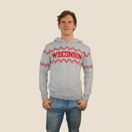 Person wearing a gray hoodie with 'Wisconsin' and red zigzag pattern on a beige background