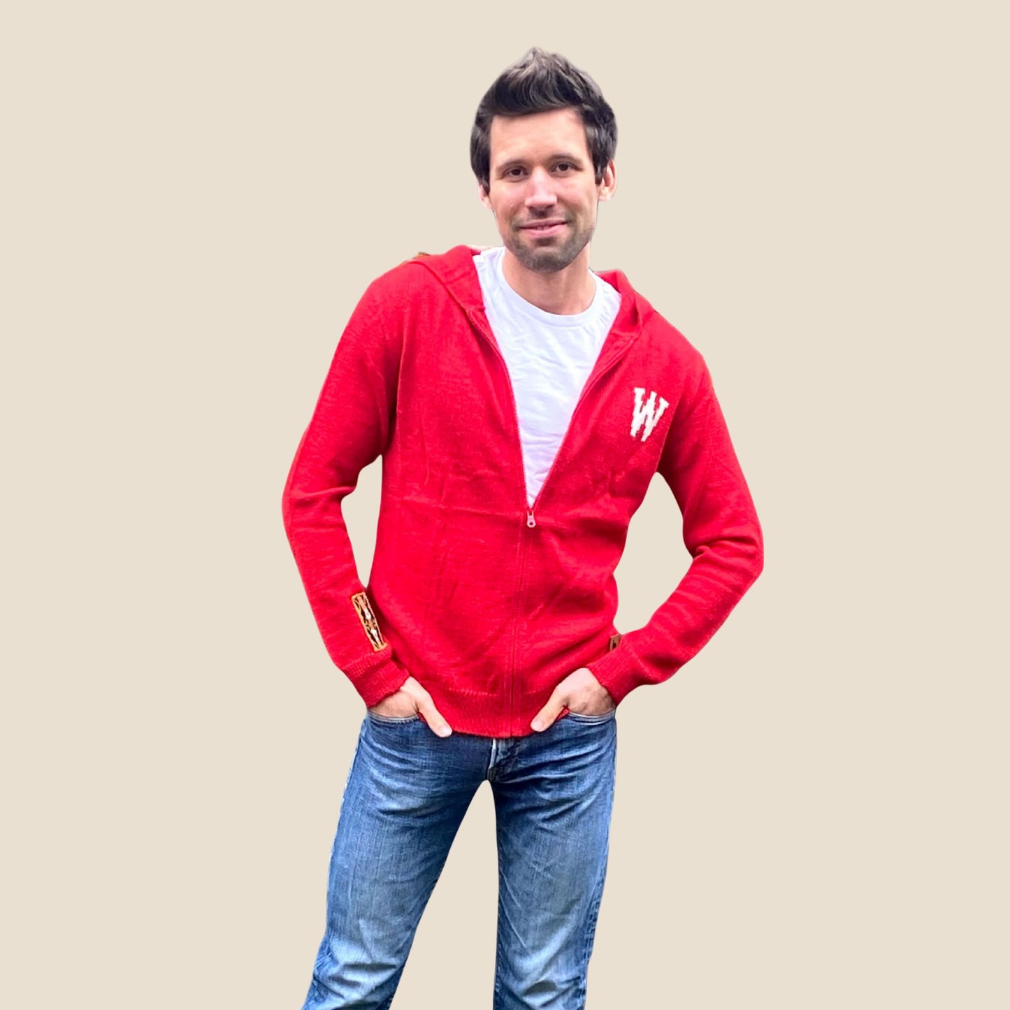 Man wearing a red hoodie with a white 'W' logo on a beige background