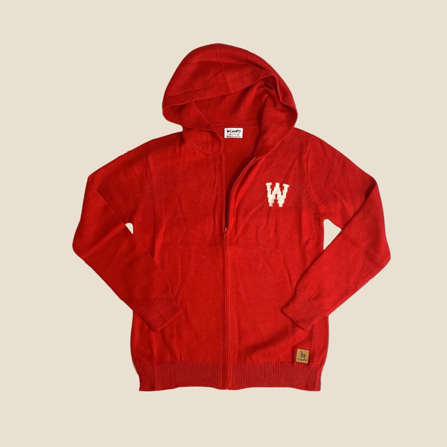Red hoodie with a logo on a beige background