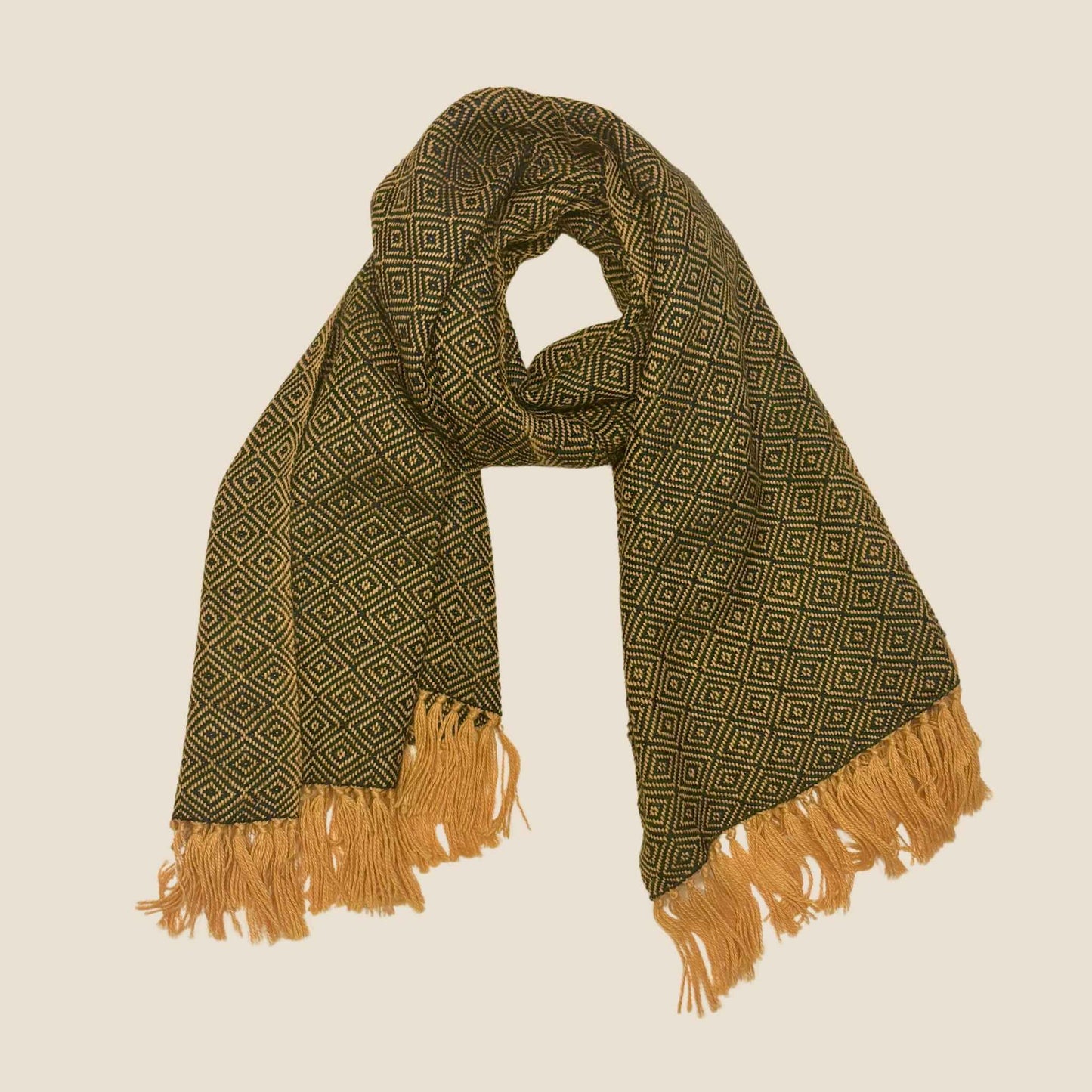 Green patterned scarf with brown fringes on a beige background